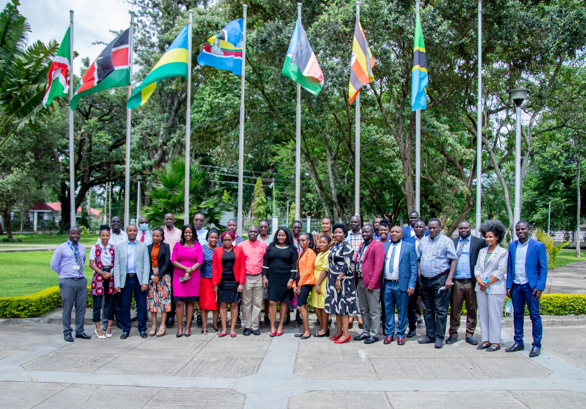 EAC team with Partner State flags in Arusha